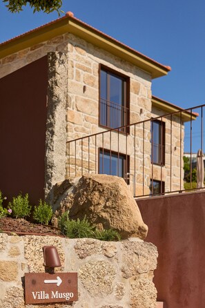 A stone building with a sign indicating 'Villa Musgo'. - Villas Carreiro - Villa Musgo | Vineyard Escape with Private Pool, Porto (Maureles)