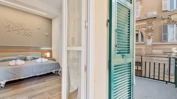 A hotel room with a bed, a nightstand, and a wall-mounted decoration.