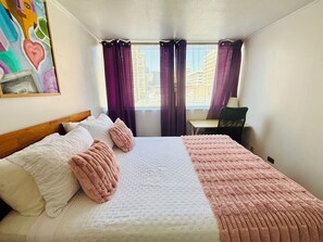 A hotel room with a bed, a desk, and a window with curtains. - Great Space for Remote Work, 5 Minutes from the Park (Santiago)