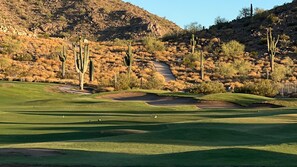 A golf course with multiple green fairways, sand bunkers, and cacti. - Enjoy breathtaking sunrises and sunsets on Johnson Ranch golf course and unforgettable stargazing from the peaceful backyard. (San Tan Valley)