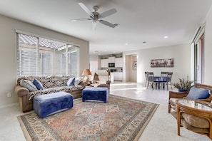 A spacious living area with a sofa, ottoman, and a dining table set for four. - Spend mornings exploring scenic desert trails, afternoons enjoying resort-style amenities, and evenings unwinding in comfort—With easy access to both Phoenix and Tucson, the location makes day trips simple (Florence)