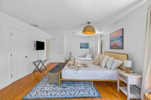 A bedroom with a bed, bedside table, lamp, and artwork. - Escape to the perfect Cape Cod getaway! (Sandwich)