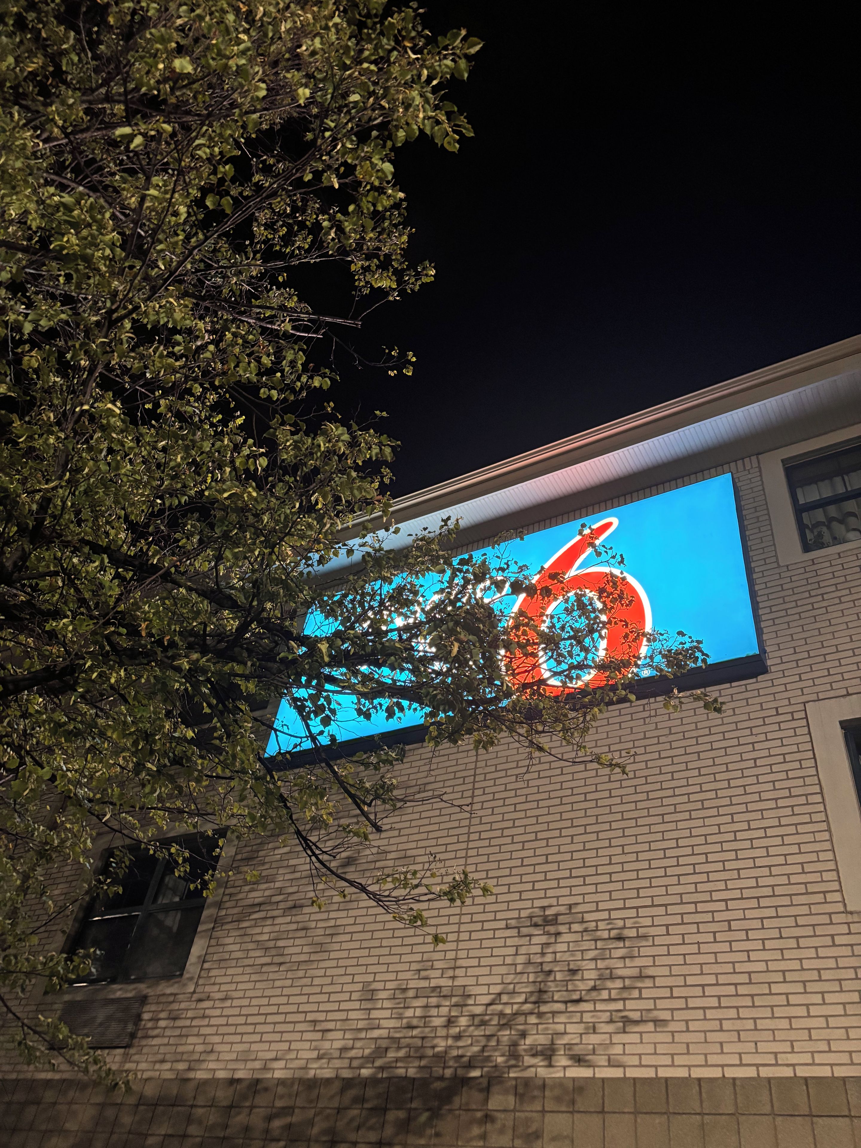 A building with a large illuminated sign on the side.