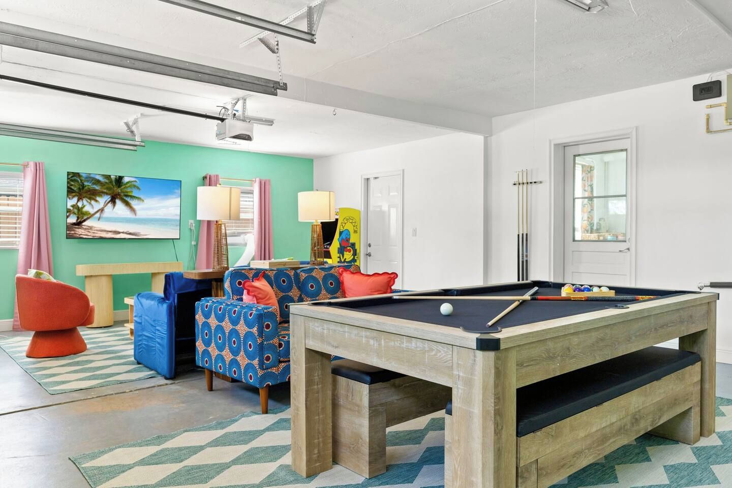 Game room with pool table, retro arcade cabinet, and a colorful lounge corner