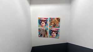 A gallery with four animal paintings on a white wall. - East London Compact Bedroom, Sleeps 1 With Wifi (London)