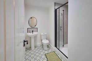 A bathroom with a white sink, toilet, and a glass shower enclosure. - Host & Stay - The Premier Loft (Middlesbrough)