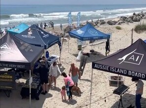 A beach with tents and people. - The Breakers Paradise - New Listing (Carolina Beach)