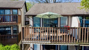 A two-story building with a balcony and a patio area. - Lake Life Starts Here! Free Boat Slip & Epic Views (Osage Beach)