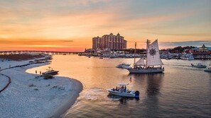 A marina with boats, a pier, and a large hotel in the background. - 🌊 2 Balconies | Gulf & Crab Island Views | 3BR Emerald Grande W1129 ☀️ (Destin)