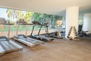 A gym with treadmills, an elliptical, and a set of dumbbells. - Comfortable Apartment Near the sea in Cartagena (Cartagena)