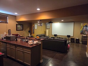 A home theater room with a large screen, a couch, and a bar area. - 10 Minute drive from Keeneland - Spacious 5-bedroom house in Nicholasville (Nicholasville)