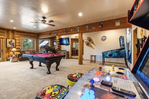 A room with a pool table, a television, and a pool table rules sign. - Sundance Lodge in Angel Fire (Angel Fire)