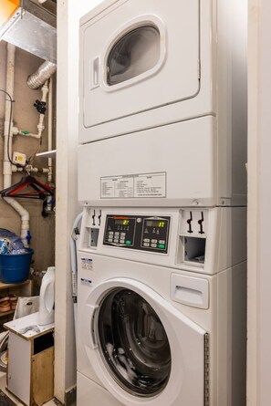 A stacked washer and dryer unit with control panels and a small window. - Utopía 1.East-Calm Loft•Optical Fiber•SelfCheckIn (Medell ín)