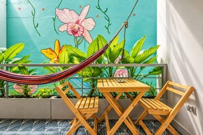 A balcony with a hammock, wooden table, and chairs. - Utopía M.East-Peacefull Loft•Wi-Fi•Self Check-In (Medellín)