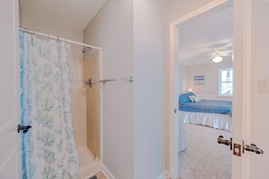 A bathroom with a shower, a door leading to a bedroom with a bed and a window. - JL #367-A Double Dare - Oceanfront - Hot Tub (South Nags Head)