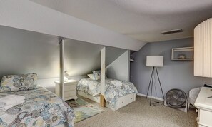 A bedroom with two beds, a bedside table, a lamp, a fan, and a wardrobe. - Dog Friendly Villa w/ Community Amenities (Hilton Head Island)
