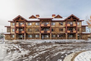 A multi-story hotel with a central courtyard, balconies, and a stone facade. - Mountain Luxury Lodge w/Gondola Access 1099 (Steamboat Springs)