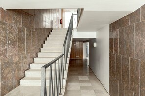 A staircase with a metal railing leading to a landing. - Bairro Alto Modern W Terrace AND Garage by Homing (Lisbon)