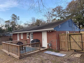 A single-story brick house with a fenced backyard, a covered patio, and a wooden deck. - Robin's Nest 3 bed/1 bath/15 mins to Ft Benning (Columbus)