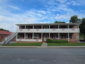A two-story building with a balcony, a staircase, and a sign that reads 'Blue Moon'.