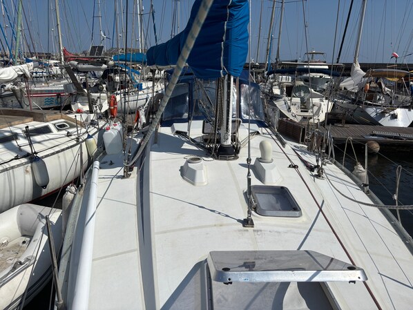 A marina with multiple sailboats docked, featuring masts, rigging, and life-saving equipment. - Spend the Night on a Sailboat in Lagos (Lagos)