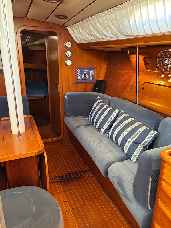 A compact interior with a sofa, a small table, and a bench.