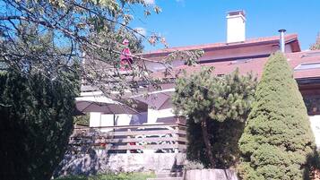 A residential area with a stone staircase leading to a house with a red roof.