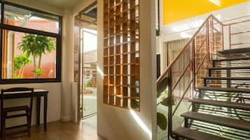 A staircase with metal railings and a wooden floor.