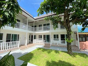 A two-story building with a balcony, a covered patio, and a well-maintained lawn. - Nai Yang Sunset (Thalang)