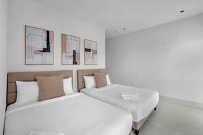A hotel room with two beds, white bedding, and abstract artwork on the wall. - Miura New Modern Miami | Luxury Villa  4BR 10PPL (Miami)