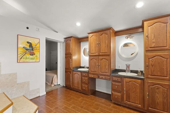A bathroom with wooden cabinets, a sink, and a mirror.