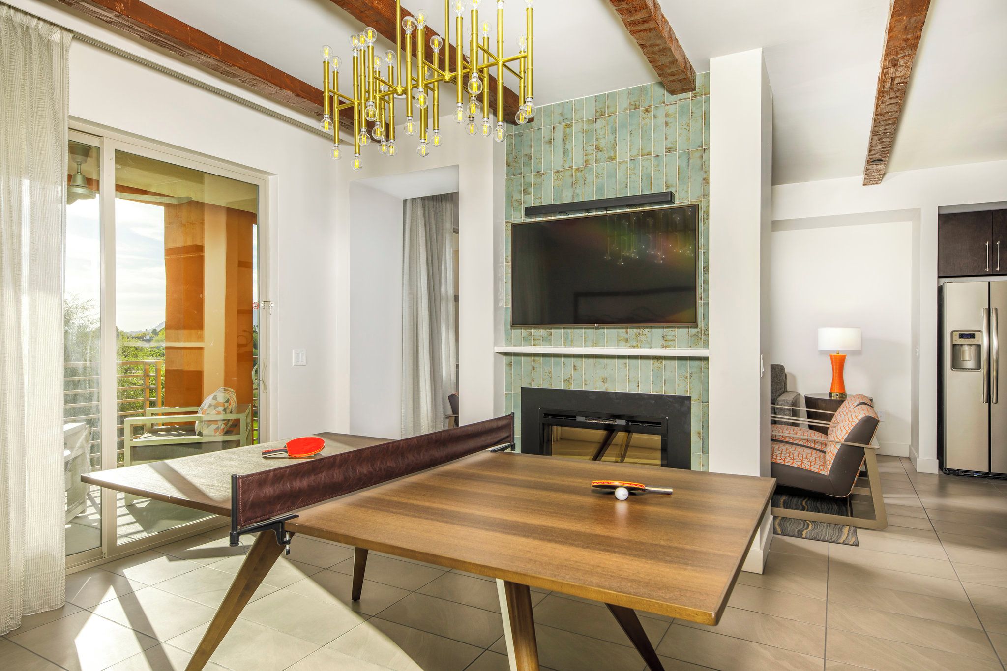 A modern living room with a dining table, sofa, and TV.