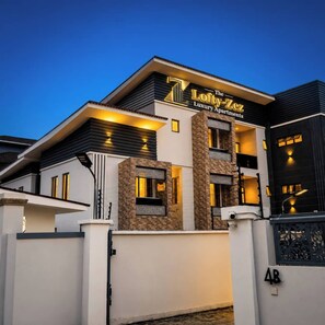 A modern two-story building with a sign for 'The Lofty-ZeZ Luxury Apartments.' - loftyzez luxury apartment  (Lekki)