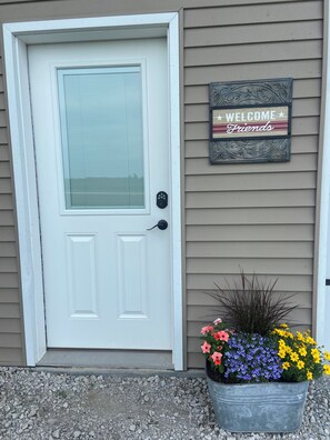 Garage walk door—enter here, 2 stairways leading to the loft apartment - Cozy studio loft apartment in rural Iowa with beautiful sunrise and sunset views (Clearfield)