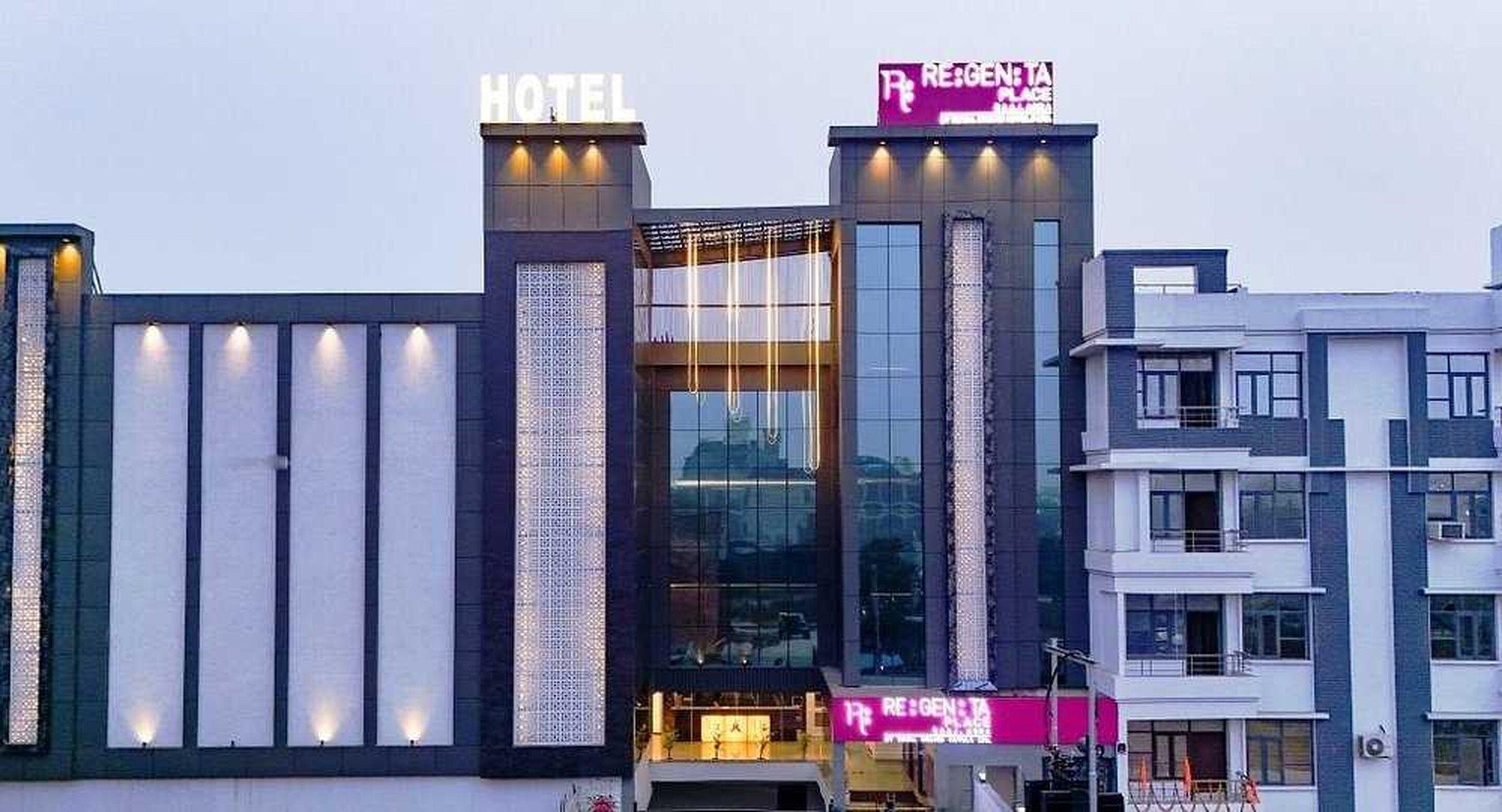 A hotel with a prominent 'HOTEL' sign and a 'REGEN' sign above the entrance.