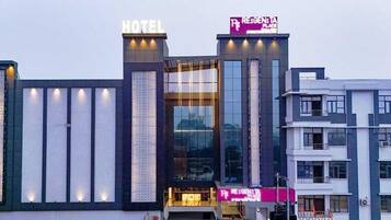 A hotel with a prominent 'HOTEL' sign and a 'REGEN' sign above the entrance.