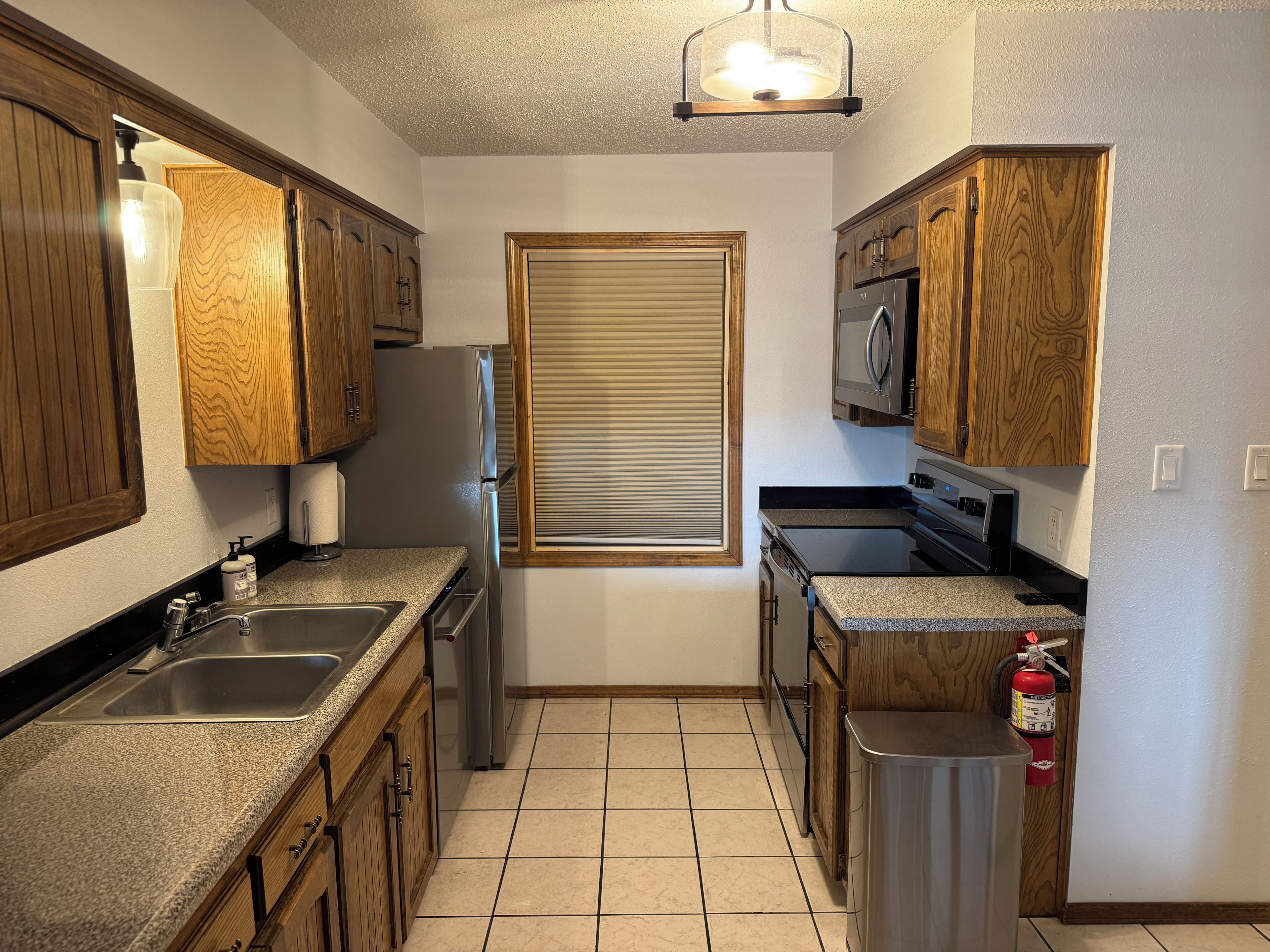 Bright galley kitchen with full-size appliances and ample counter space