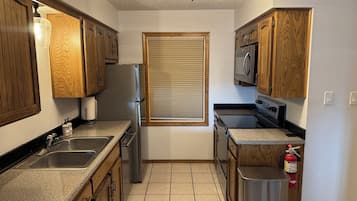 Bright galley kitchen with full-size appliances and ample counter space