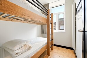 A bunk bed with a wooden ladder, a white mattress, and a pillow. - Spacious Family Blankenberge House (Blankenberge)