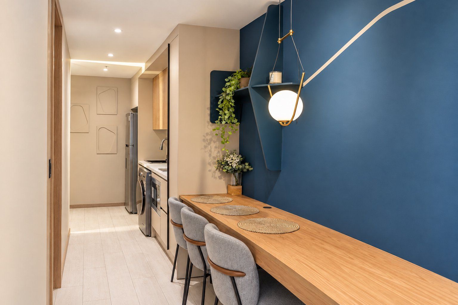 A modern kitchen with a wooden countertop, grey chairs, and a blue accent wall.