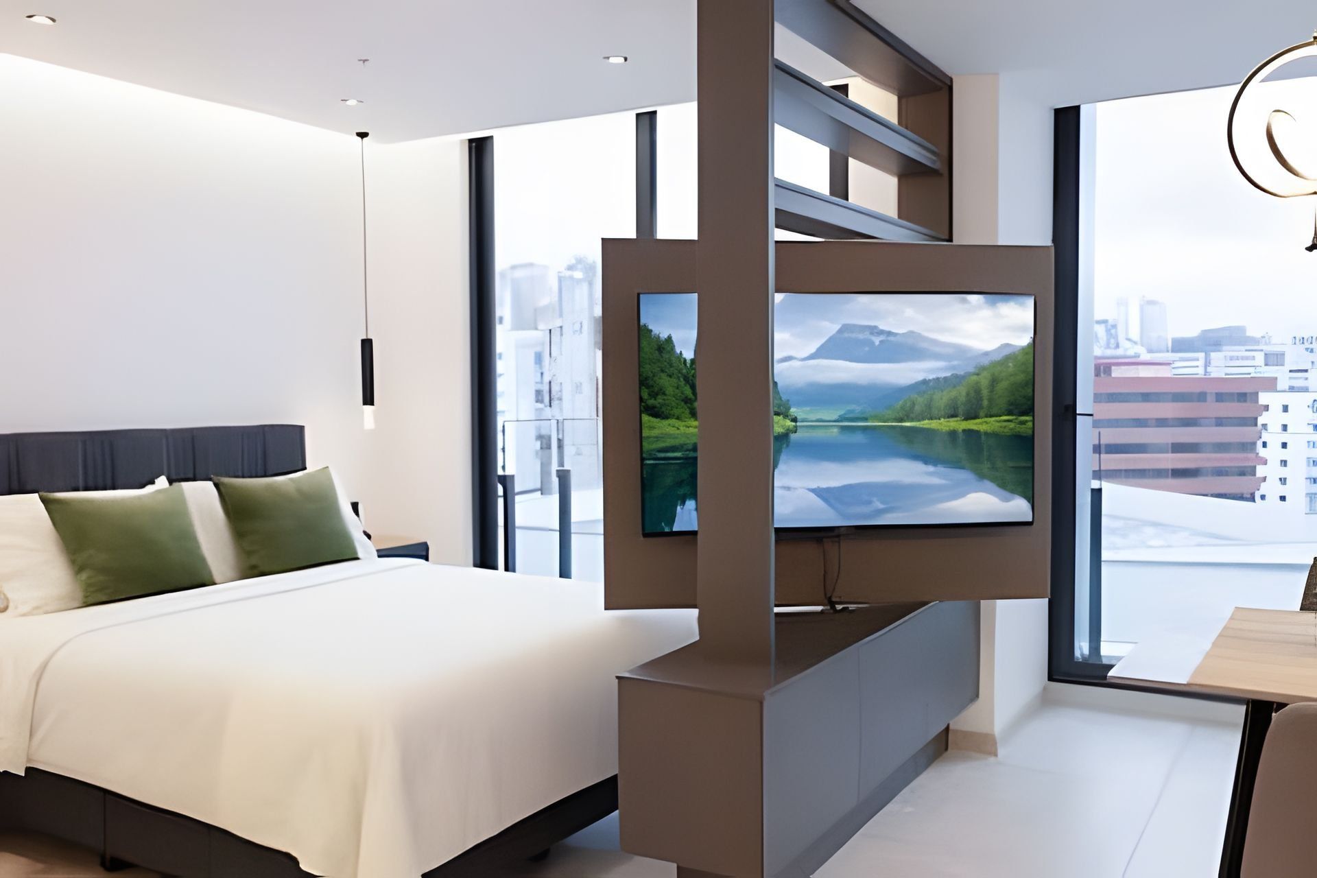 A modern bedroom with a large bed, a flat-screen TV mounted on a wall, and a city view through large windows.
