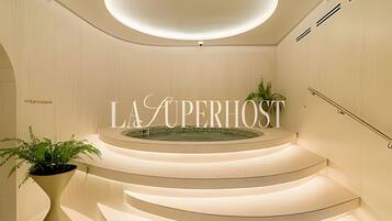 A modern interior with a central circular platform and the words 'LA SUPERIOST' prominently displayed.