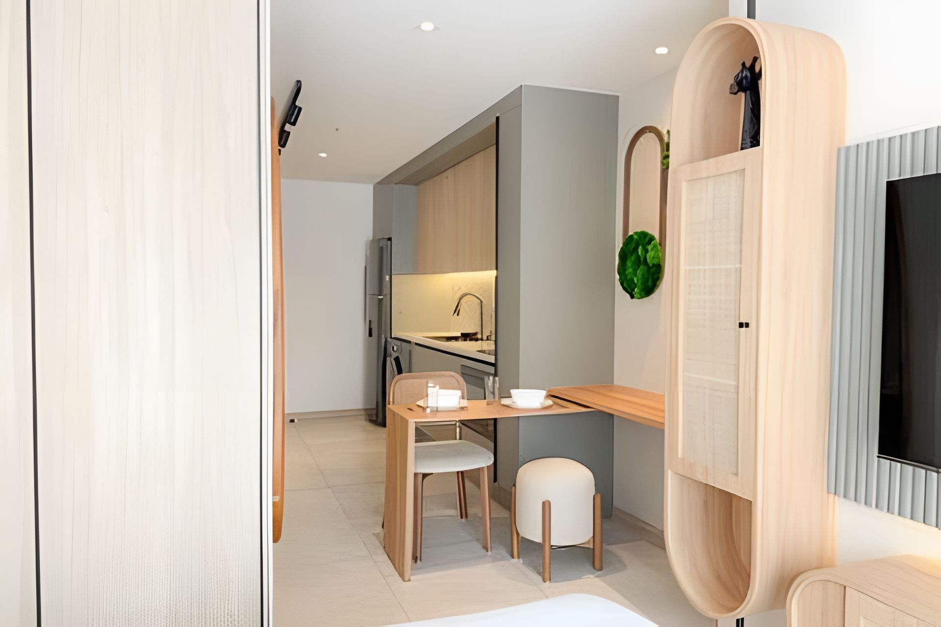 A modern kitchen with a dining area, a wooden table, and chairs.