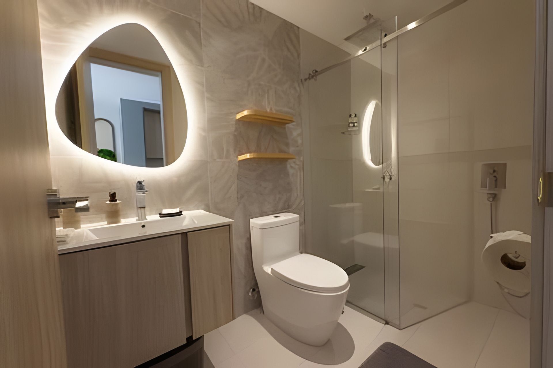 A modern bathroom with a toilet, sink, and glass shower enclosure.