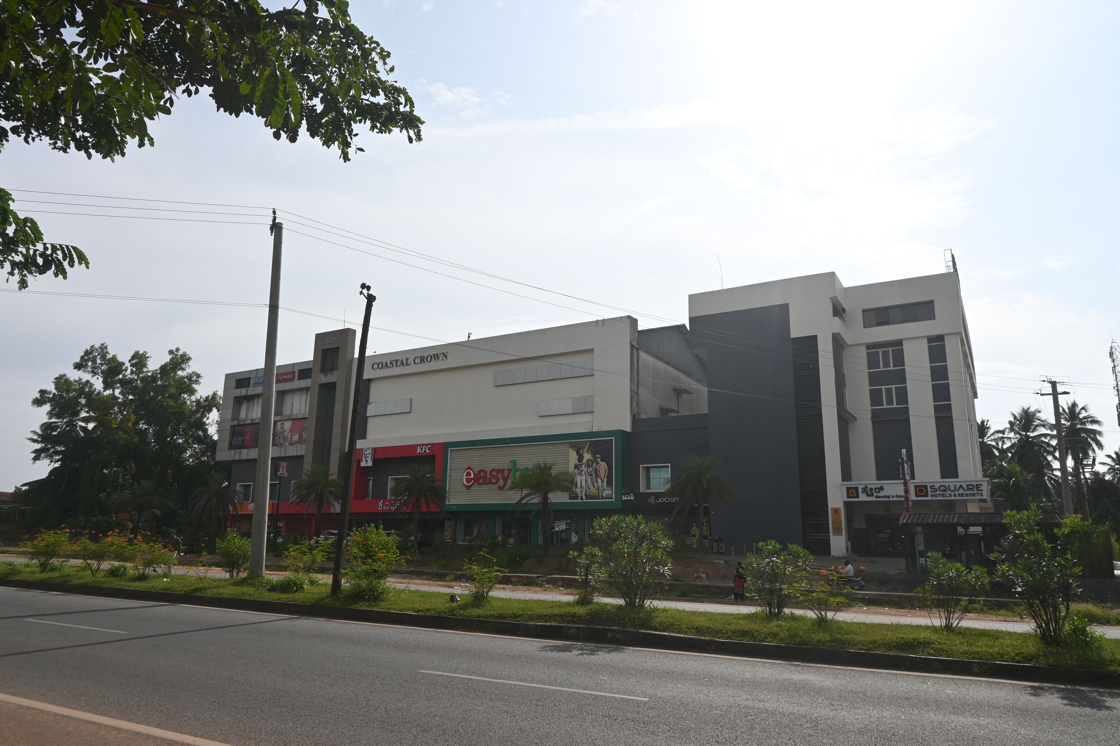 A multi-story building with a KFC restaurant, a cinema, and a hotel.