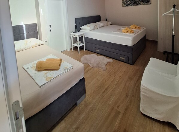 A hotel room with a bed, bedside table, and a chair. - Two Bedroom Holiday Home with Outdoor Swimming Pool (Murter)