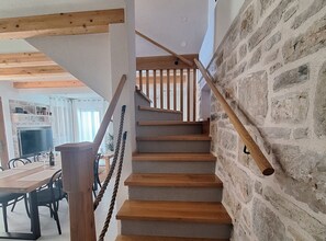 A staircase with wooden steps and a stone wall. - Two Bedroom Holiday Home with Outdoor Swimming Pool (Murter)