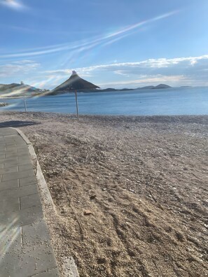 A paved walkway beside a body of water with a distant mountain and a rainbow. - Apartment 'Panorama' with Sea View, Wi-Fi and Air Conditioning (Pakoštane)