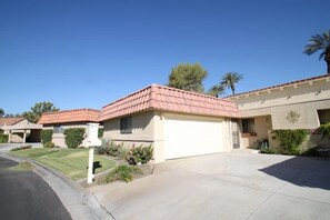 A residential area with houses featuring red-tiled roofs and beige walls. - Spacious and Comfy on the 15th Fairway! (Palm Desert)