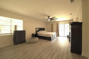 A bedroom with a bed, a dresser, a ceiling fan, and a window with blinds. - Pet Friendly Home with Private Pool, Home Gym, Ping Pong Table & Wifi (Fort Walton Beach)